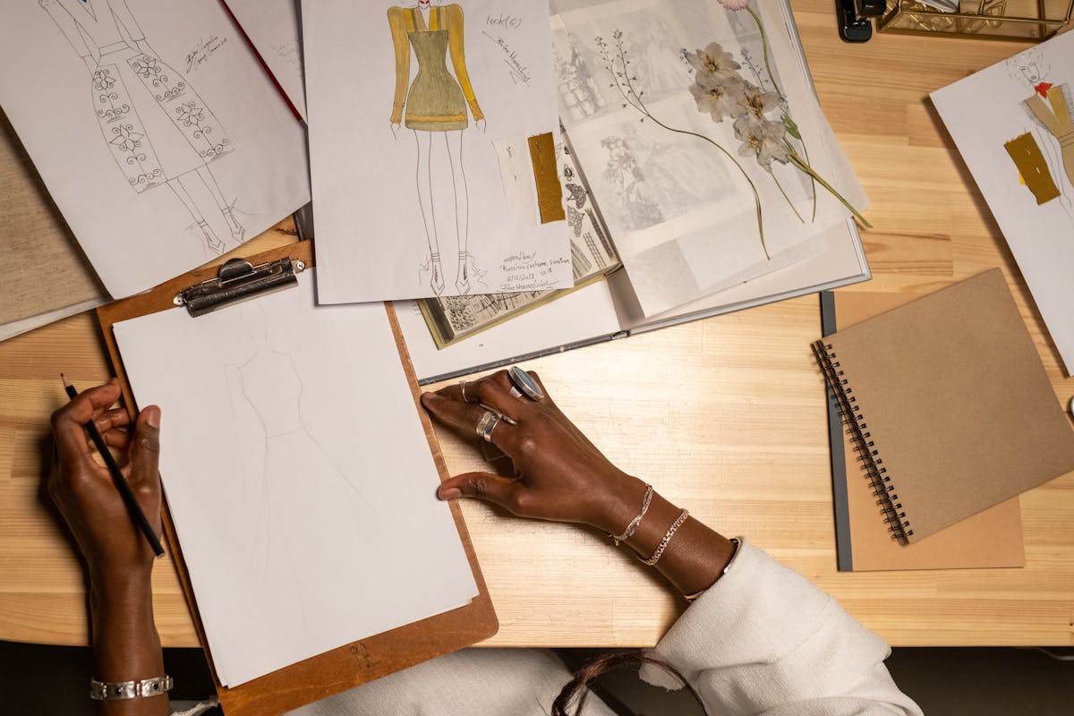 Fashion designer sketching at an atelier desk