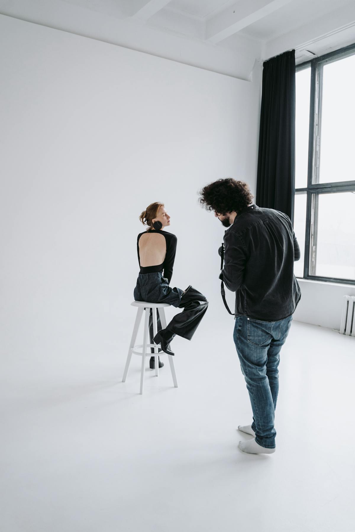 Fashion photographer at work in a minimal studio